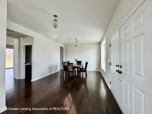 2632 Carnoustie Dr, Okemos, MI 48864 - dining room with a chandelier, baseboards, a textured ceiling, and dark wood finished floors