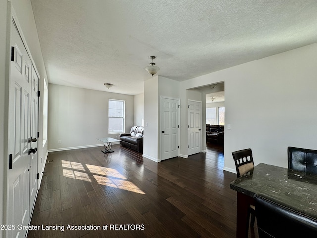 2632 Carnoustie Dr, Okemos, MI 48864 - dining area featuring baseboards, a textured ceiling, and dark wood finished floors