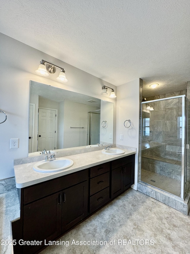 2632 Carnoustie Dr, Okemos, MI 48864 - bathroom with a stall shower, double vanity, a sink, and a textured ceiling