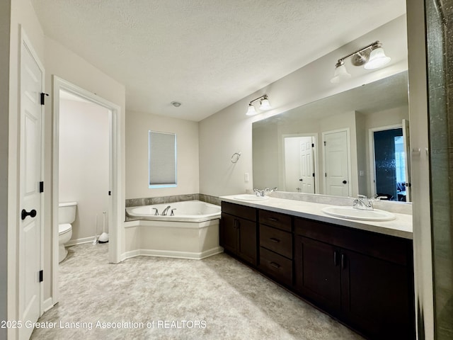 2632 Carnoustie Dr, Okemos, MI 48864 - full bathroom with double vanity, a garden tub, a sink, and toilet