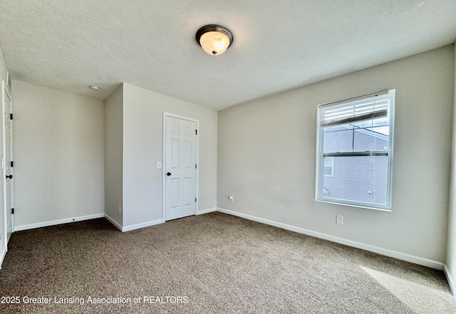 2632 Carnoustie Dr, Okemos, MI 48864 - empty room featuring baseboards, carpet flooring, and a textured ceiling