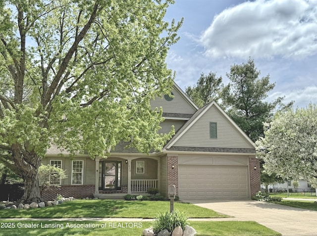 1970 Hollowbrook Dr, Holt, MI 48842 - view of front of home featuring covered porch, brick siding, concrete driveway, and a garage