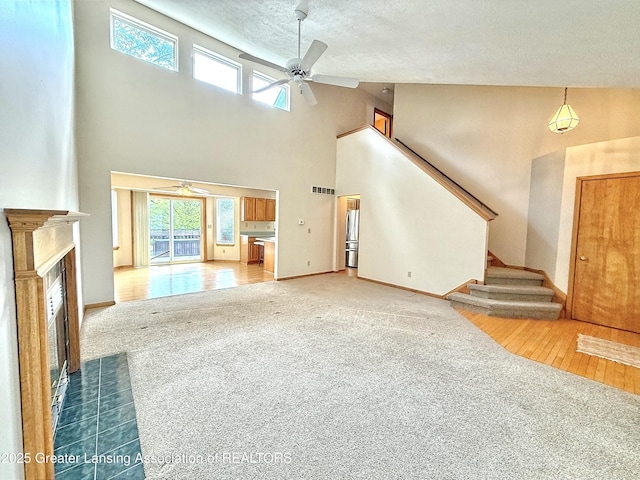 1970 Hollowbrook Dr, Holt, MI 48842 - unfurnished living room featuring a ceiling fan, carpet flooring, and a textured ceiling
