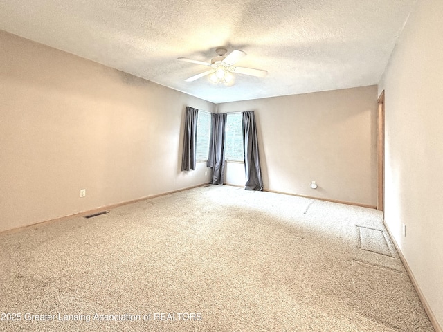 1970 Hollowbrook Dr, Holt, MI 48842 - carpeted spare room with a textured ceiling, ceiling fan, visible vents, and baseboards