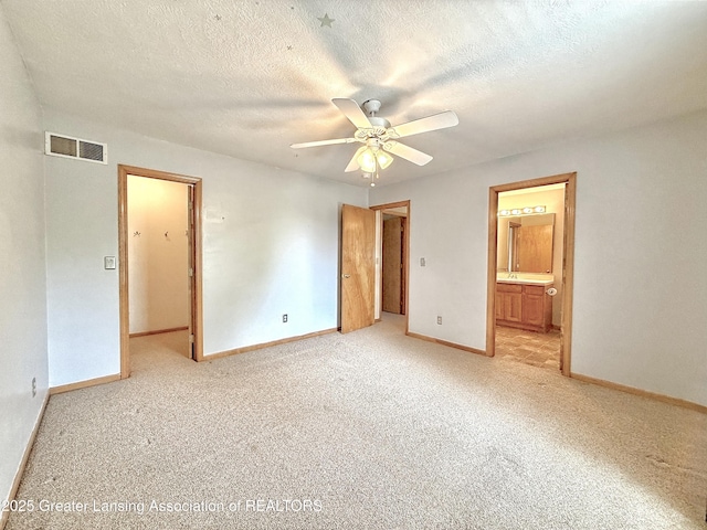 1970 Hollowbrook Dr, Holt, MI 48842 - unfurnished bedroom featuring baseboards, light colored carpet, a textured ceiling, and visible vents
