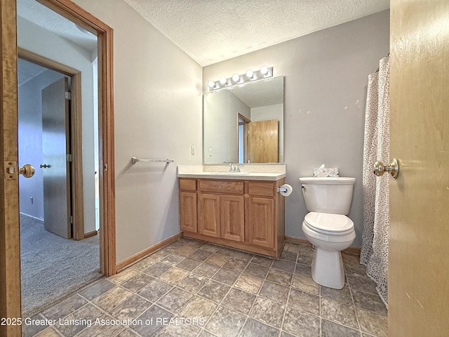 1970 Hollowbrook Dr, Holt, MI 48842 - full bathroom with vanity, toilet, a textured ceiling, stone finish floor, and baseboards