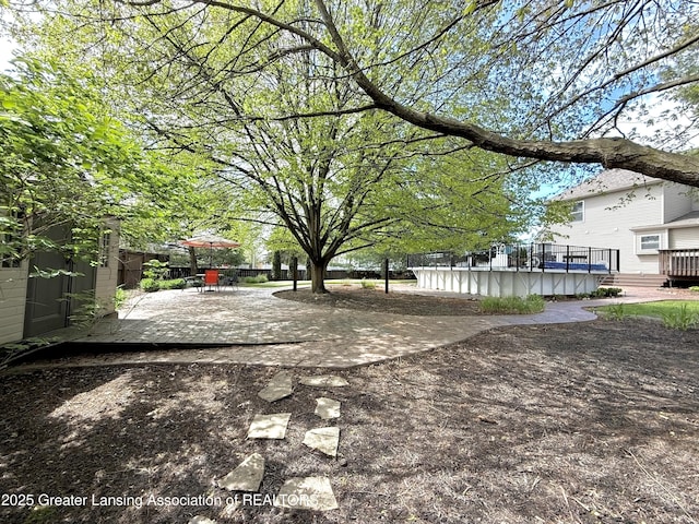 1970 Hollowbrook Dr, Holt, MI 48842 - view of yard with an outdoor structure, a patio area, and a wooden deck