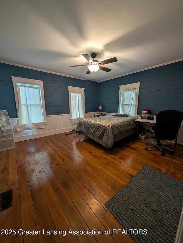 bedroom featuring crown molding, visible vents, and hardwood / wood-style flooring