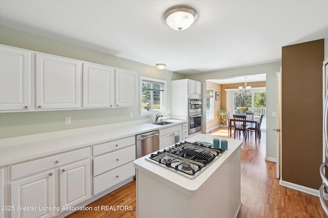 14178 Mulholland Dr, Bath, MI 48808 - kitchen with an inviting chandelier, appliances with stainless steel finishes, light wood finished floors, and a healthy amount of sunlight