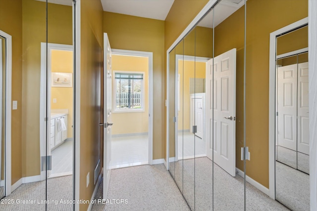14178 Mulholland Dr, Bath, MI 48808 - corridor with baseboards and light carpet