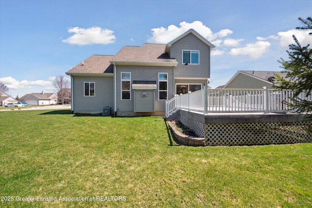 14178 Mulholland Dr, Bath, MI 48808 - rear view of property featuring a lawn, a wooden deck, and a shingled roof