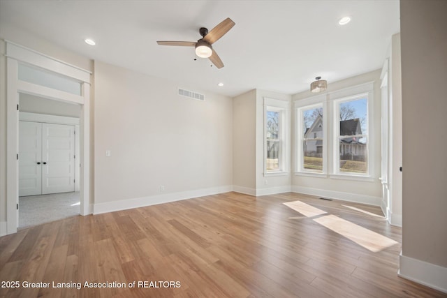 unfurnished room with visible vents, ceiling fan, light wood-type flooring, and recessed lighting