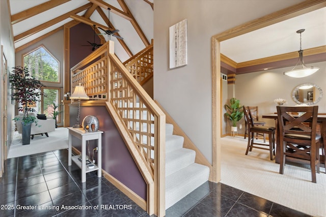 5810 Caleta Dr, Lansing, MI 48911 - stairs featuring high vaulted ceiling, baseboards, and tile patterned flooring