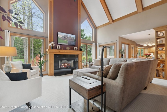 5810 Caleta Dr, Lansing, MI 48911 - carpeted living room featuring high vaulted ceiling, a fireplace with flush hearth, beamed ceiling, and a chandelier