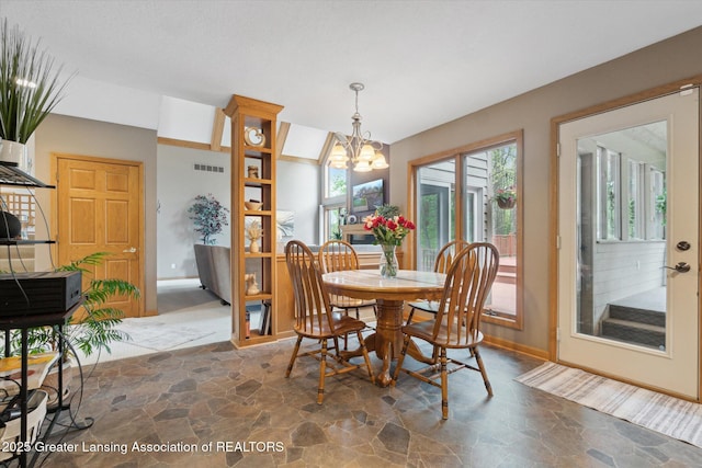 5810 Caleta Dr, Lansing, MI 48911 - dining space with stone flooring, a chandelier, and baseboards