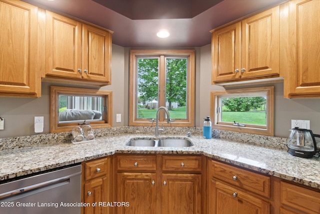 5810 Caleta Dr, Lansing, MI 48911 - kitchen with dishwasher, a sink, light stone countertops, and recessed lighting