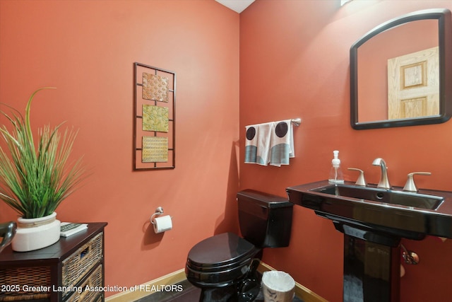 5810 Caleta Dr, Lansing, MI 48911 - half bathroom with toilet and baseboards