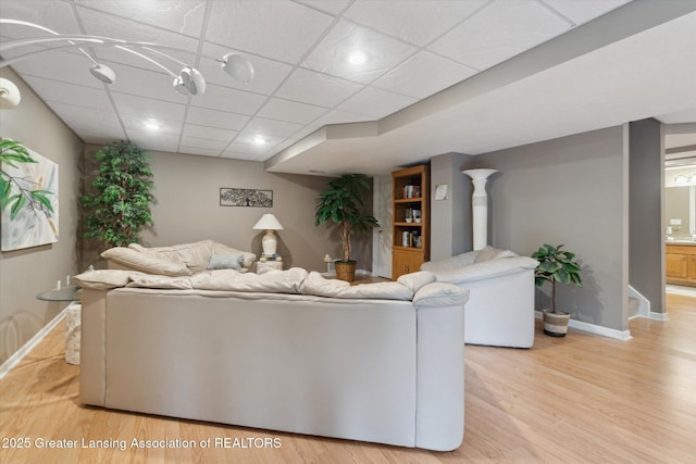 5810 Caleta Dr, Lansing, MI 48911 - living room with baseboards, light wood-type flooring, and a drop ceiling