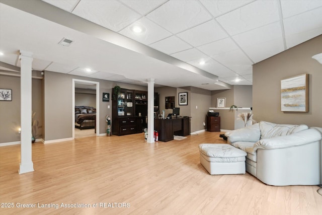 5810 Caleta Dr, Lansing, MI 48911 - living area with light wood-style floors, a drop ceiling, baseboards, decorative columns, and recessed lighting
