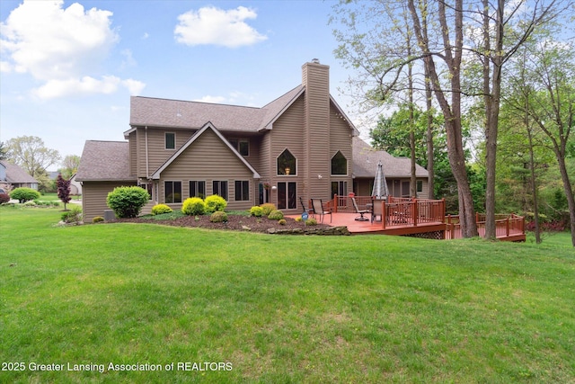 5810 Caleta Dr, Lansing, MI 48911 - back of house featuring a chimney, a lawn, a deck, and a shingled roof