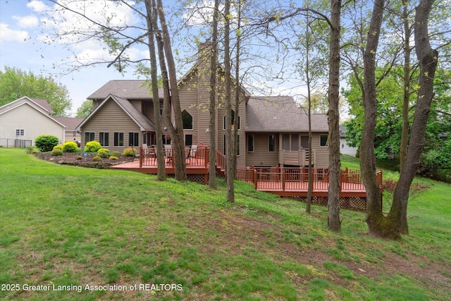 5810 Caleta Dr, Lansing, MI 48911 - rear view of property with a deck, a yard, and roof with shingles