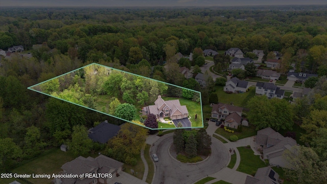 5810 Caleta Dr, Lansing, MI 48911 - aerial perspective of suburban area featuring a heavily wooded area and property parcel outlined
