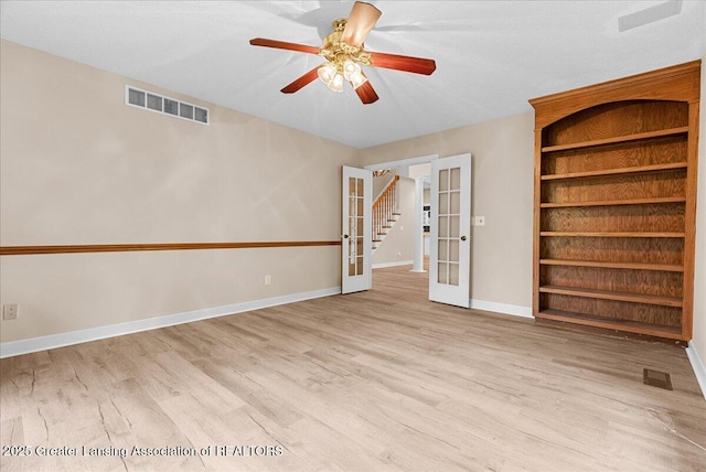 4345 Courtside Dr, Williamston, MI 48895 - unfurnished room featuring french doors, wood finished floors, baseboards, and ceiling fan