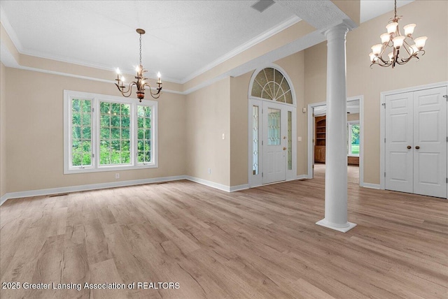 4345 Courtside Dr, Williamston, MI 48895 - entrance foyer with a chandelier, ornate columns, light wood-type flooring, crown molding, and baseboards