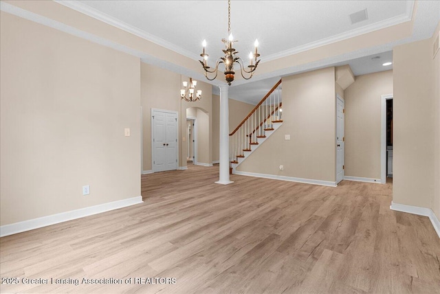4345 Courtside Dr, Williamston, MI 48895 - unfurnished living room with a chandelier, light wood-type flooring, ornamental molding, baseboards, and stairs