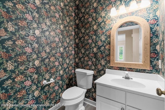 4345 Courtside Dr, Williamston, MI 48895 - bathroom with wallpapered walls, toilet, and vanity