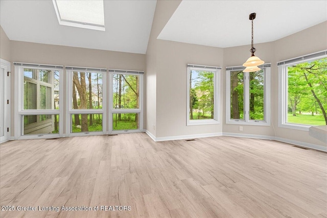 4345 Courtside Dr, Williamston, MI 48895 - unfurnished living room featuring baseboards, wood finished floors, and lofted ceiling