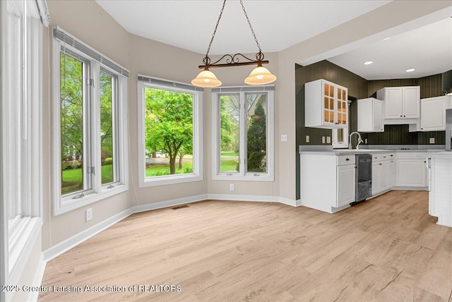 4345 Courtside Dr, Williamston, MI 48895 - kitchen featuring dishwasher, healthy amount of natural light, and white cabinets