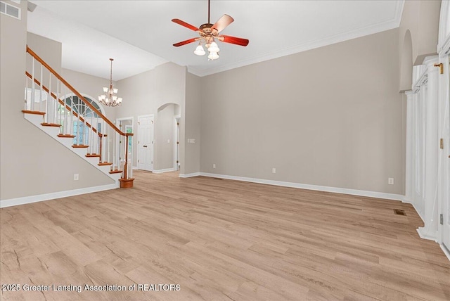 4345 Courtside Dr, Williamston, MI 48895 - unfurnished living room featuring arched walkways, ceiling fan, light wood-style floors, stairway, and baseboards