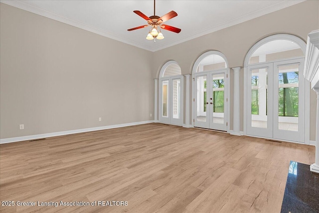 4345 Courtside Dr, Williamston, MI 48895 - unfurnished room with french doors, light wood-type flooring, a ceiling fan, crown molding, and baseboards