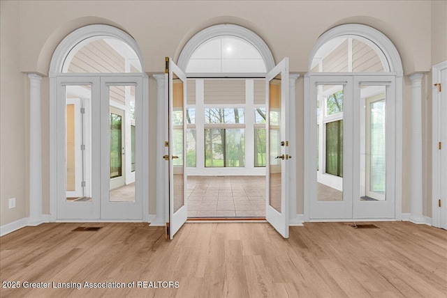 4345 Courtside Dr, Williamston, MI 48895 - entrance foyer featuring french doors, light wood finished floors, and baseboards