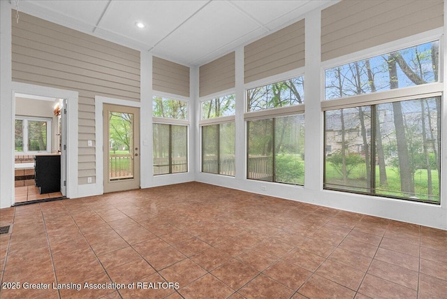 4345 Courtside Dr, Williamston, MI 48895 - unfurnished sunroom featuring plenty of natural light, tile patterned flooring, a high ceiling, recessed lighting, and wooden walls