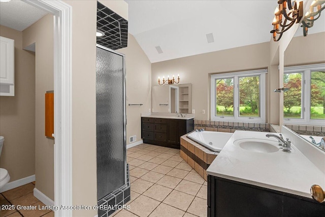 4345 Courtside Dr, Williamston, MI 48895 - bathroom with tile patterned flooring, a stall shower, a garden tub, toilet, and two vanities