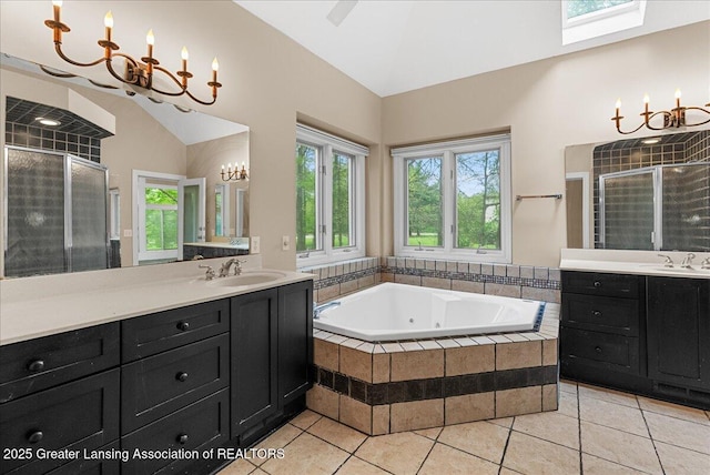 4345 Courtside Dr, Williamston, MI 48895 - full bathroom featuring a chandelier, a stall shower, a whirlpool tub, tile patterned floors, and vanity