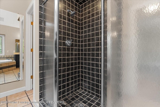 4345 Courtside Dr, Williamston, MI 48895 - bathroom with a stall shower, tile patterned flooring, and a garden tub