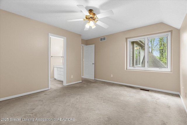 4345 Courtside Dr, Williamston, MI 48895 - unfurnished bedroom with carpet floors, baseboards, connected bathroom, and ceiling fan