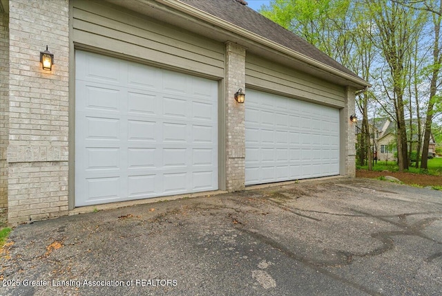 4345 Courtside Dr, Williamston, MI 48895 - garage featuring driveway
