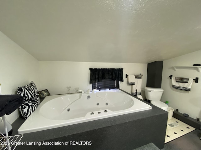 full bath with a whirlpool tub, toilet, and lofted ceiling