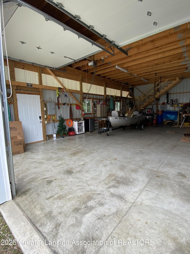 garage featuring electric panel and a garage door opener