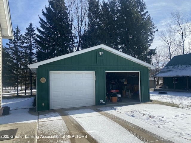 snow covered garage with a garage