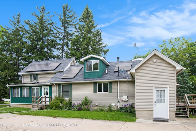 1588 N Chipman Rd, Owosso, MI 48867 - view of front of home with solar panels and a shingled roof