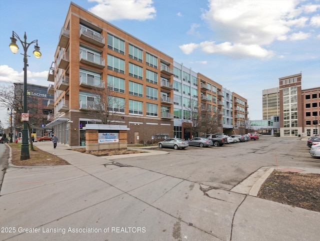 view of building exterior featuring uncovered parking
