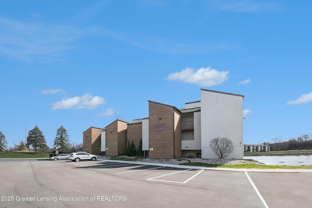 view of building exterior featuring uncovered parking