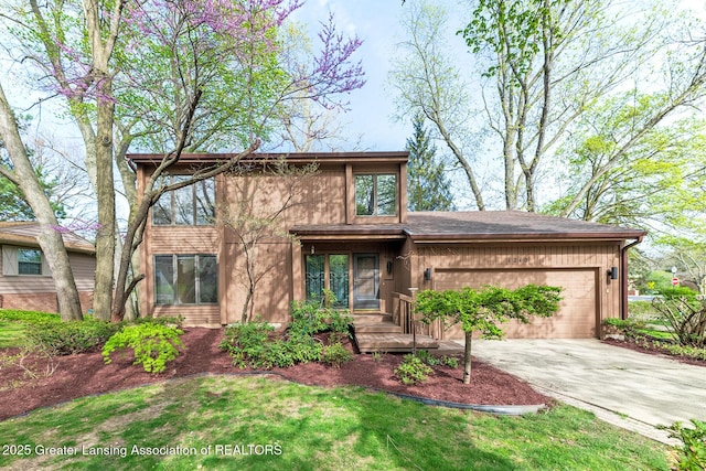 1210 Whittier Dr, East Lansing, MI 48823 - view of front of property with an attached garage and concrete driveway