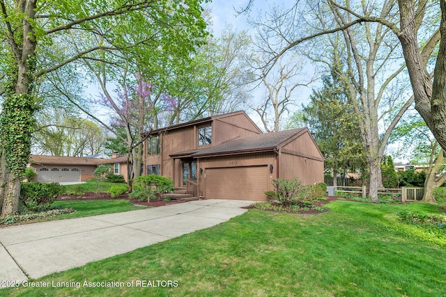 1210 Whittier Dr, East Lansing, MI 48823 - traditional home with concrete driveway, a front lawn, and a garage