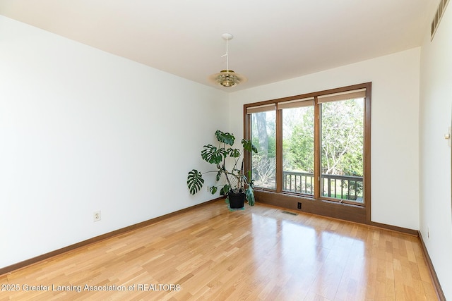 1210 Whittier Dr, East Lansing, MI 48823 - empty room with baseboards, light wood-style flooring, and visible vents